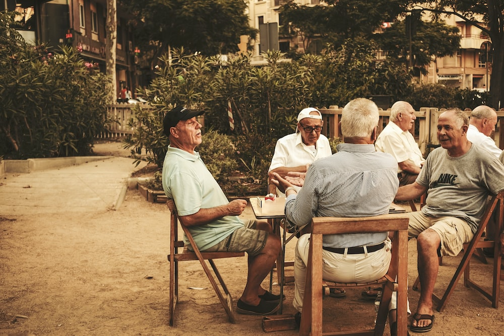 a group of old men sitting around a table