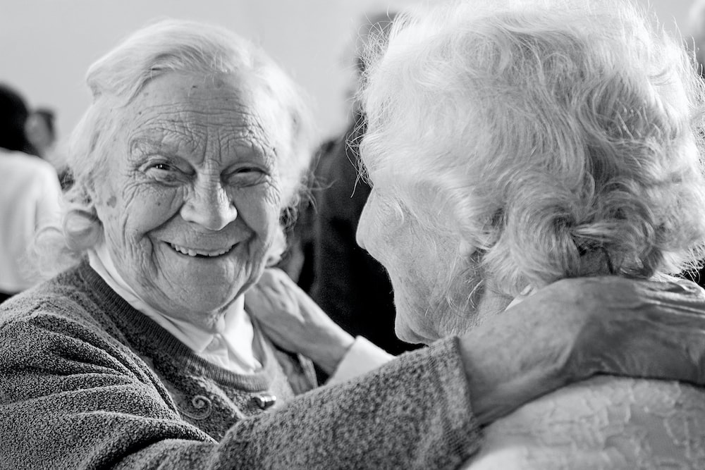 a grayscale image of two old women